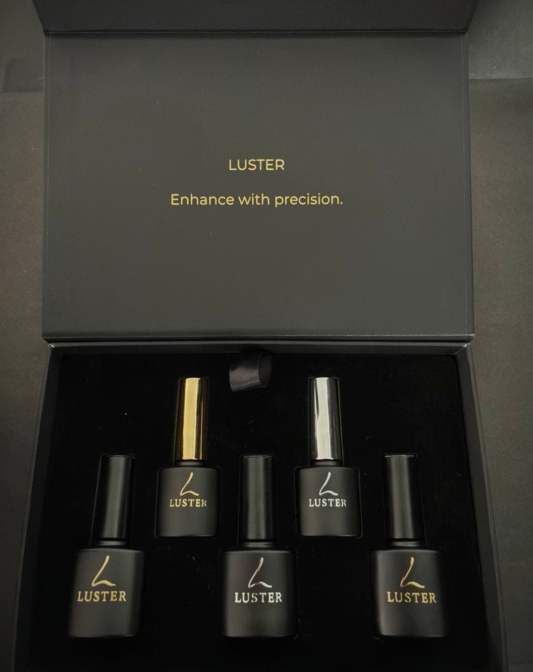 LUSTER presentation box open on black velvet, holding five matte black builder gel bottles